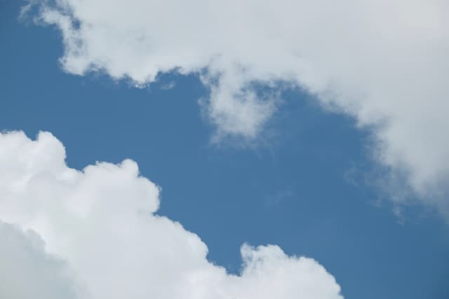 Blue sky framed by white clouds